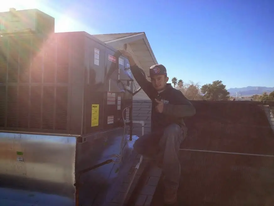 HVAC technician performing HVAC Inspection on a rooftop unit in Kansas City